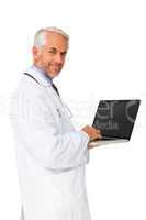 Portrait of a content male doctor using laptop