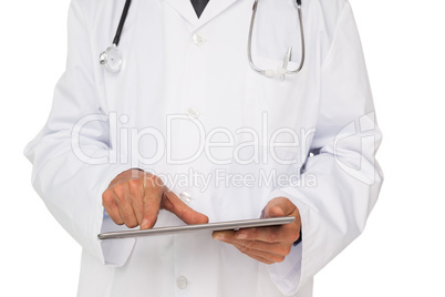 Mid section of a male doctor using digital tablet