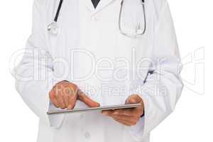 Mid section of a male doctor using digital tablet