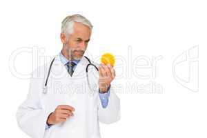 Concentrated male doctor looking at stress ball