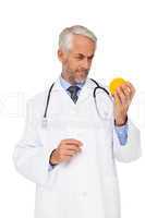 Concentrated male doctor looking at stress ball