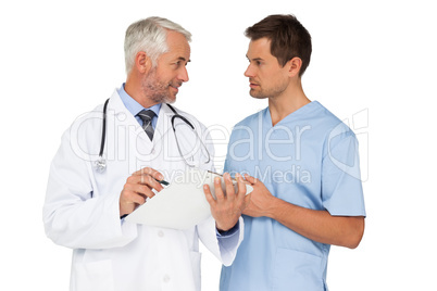 Male doctor and surgeon discussing reports