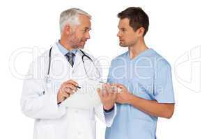 Male doctor and surgeon discussing reports