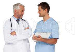 Male doctor and surgeon discussing reports