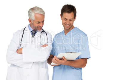 Male doctor and surgeon discussing reports