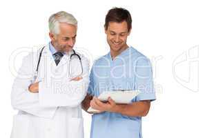 Male doctor and surgeon discussing reports