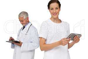 Male and female doctors using digital tablets