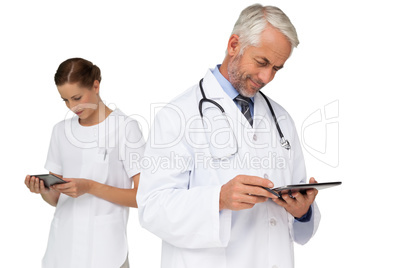 Male and female doctors using digital tablets