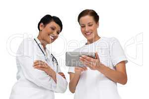 Two female doctors using digital tablet