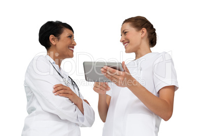 Two female doctors using digital tablet