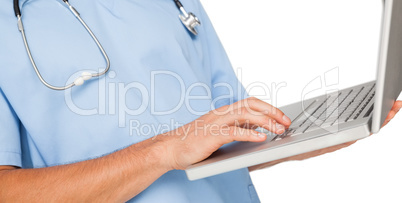 Close-up mid section of a male surgeon using laptop Close-up mid section of a male surgeon using laptop