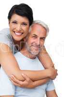 Portrait of a happy woman embracing man from behind