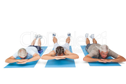 Full length of three men exercising