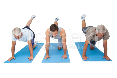 Full length of three men exercising