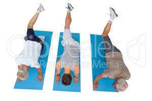 Full length of three men exercising
