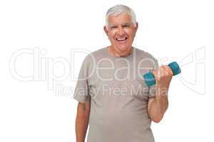 Portrait of a happy senior man exercising with dumbbell