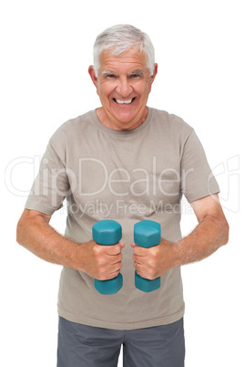 Portrait of a happy senior man exercising with dumbbells