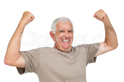 Portrait of a cheerful senior man with clenched fists