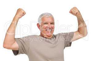 Portrait of a cheerful senior man with clenched fists