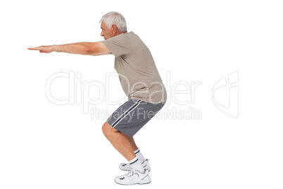 Full length side view of a senior man stretching hands