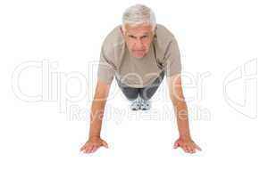 Portrait of a senior man doing push ups
