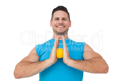 Portrait of a content young man holding stress ball