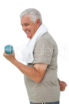 Side view of a senior man exercising with dumbbell