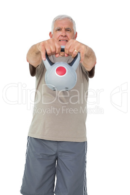 Portrait of a senior man exercising with kettle bell