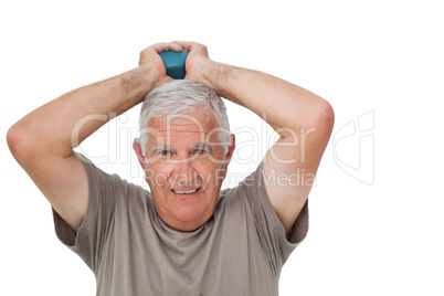 Portrait of a senior man holding dumbbell