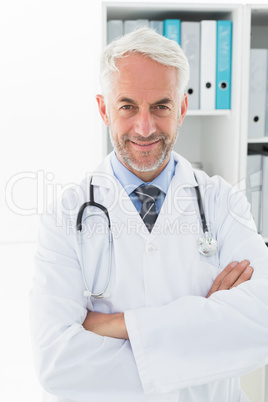 Smiling confident male doctor at medical office