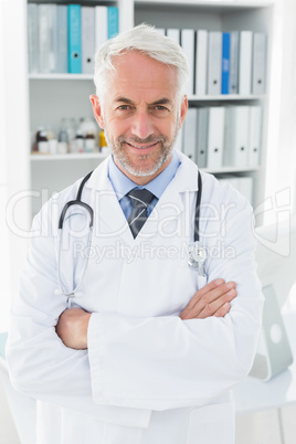 Portrait of a smiling confident male doctor at medical office Portrait of a smiling confident male doctor at medical office