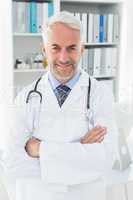 Portrait of a smiling confident male doctor at medical office