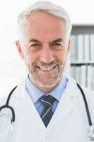 Smiling confident male doctor at medical office