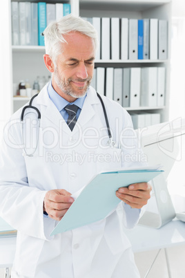 Doctor looking at a folder in the medical office