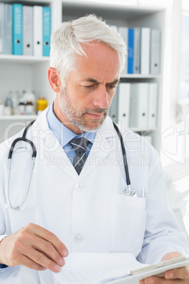 Doctor looking at reports in the medical office