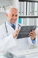 Doctor using digital tablet at medical office