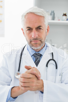 Serious confident male doctor at medical office