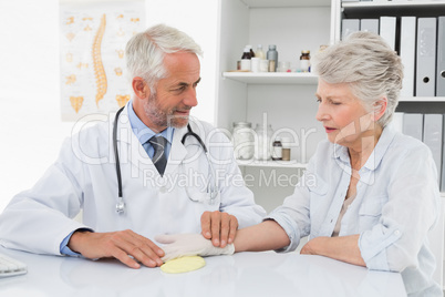 Doctor taking a senior female's pulse
