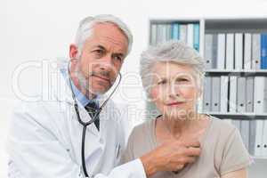 Doctor checking patients heartbeat using stethoscope