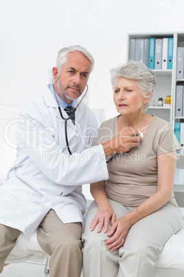 Doctor checking patients heartbeat using stethoscope