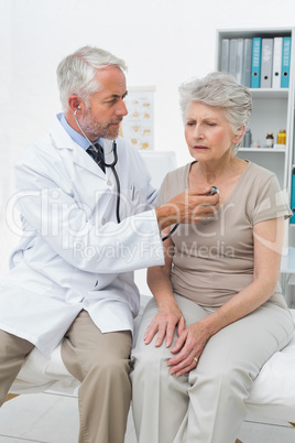 Doctor checking patients heartbeat using stethoscope