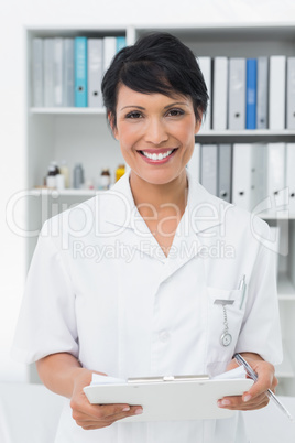Smiling confident female doctor at medical office