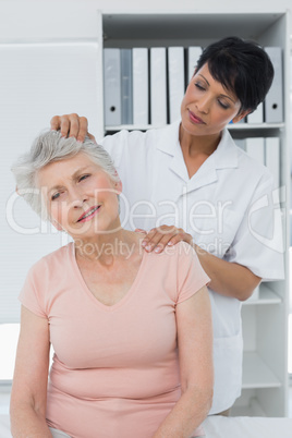 Female chiropractor doing neck adjustment