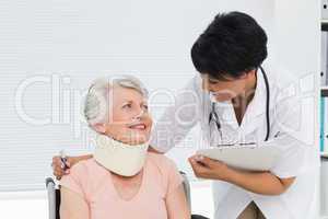 Doctor talking to a senior patient with cervical collar