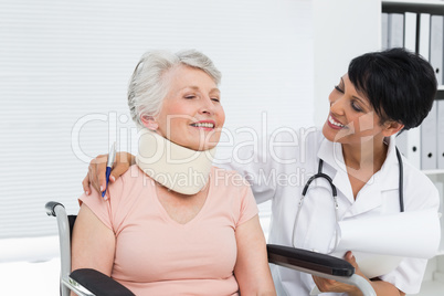 Doctor talking to a senior patient with cervical collar