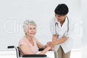 Doctor talking to a senior patient in wheelchair