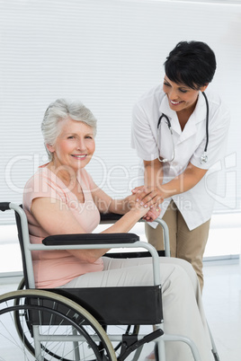 Doctor talking to a senior patient in wheelchair