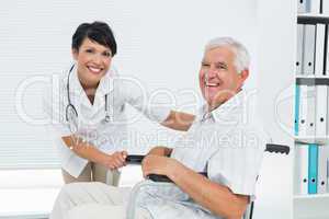 Female doctor with senior patient in wheelchair