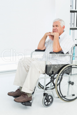 Side view of a sad senior man sitting in wheelchair