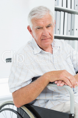 Portrait of a sad senior man sitting in wheelchair